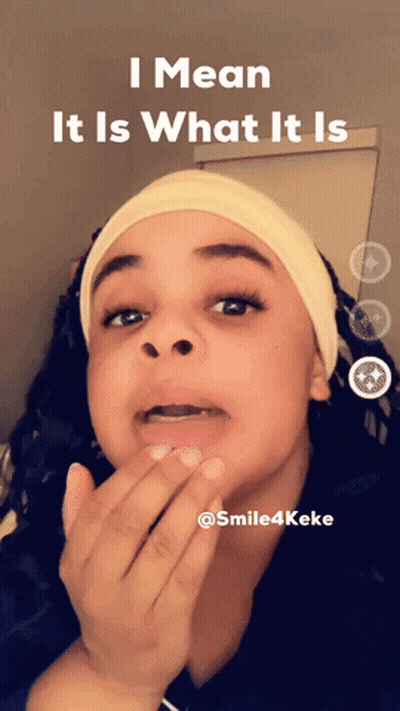A Woman Covering Her Mouth With Her Hand And The Words I Mean It Is What It Is Above Her GIF