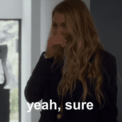 A Woman Covering Her Mouth With Her Hand With The Words Yeah Sure Written Below Her GIF