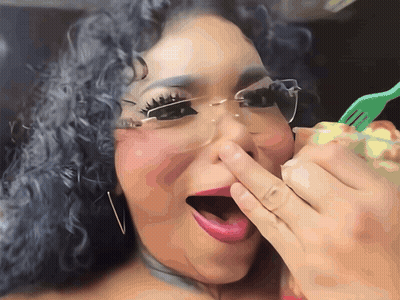 A Woman Covering Her Nose With Her Hand While Holding A Fork GIF