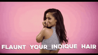 A Woman Covering Her Nose With Her Hand With The Words Flaunt Your Indicque Hair Written Below Her GIF