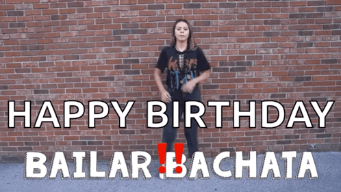 A Woman Dancing In Front Of A Brick Wall That Says Happy Birthday GIF