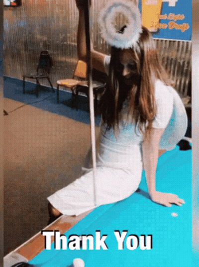 A Woman Dressed As An Angel Is Sitting On A Pool Table With The Words Thank You Written Below Her GIF