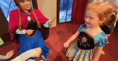 A Woman Dressed As Anna And A Little Girl Dressed As Elsa Are Dancing Together . GIF