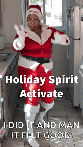 A Woman Dressed As Santa Claus Is Dancing In A Kitchen With The Caption Holiday Spirit Activate I Did It And Man It Felt GIF