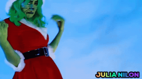 A Woman Dressed As The Grinch Has Julianilon Written On The Bottom Right GIF