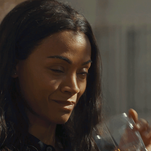 A Woman Drinking A Glass Of Whiskey With A Watch On Her Wrist GIF