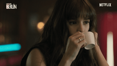 A Woman Drinking From A Cup With A Netflix Logo In The Corner GIF