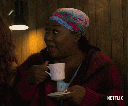 A Woman Drinking From A Cup With Netflix Written On The Bottom GIF