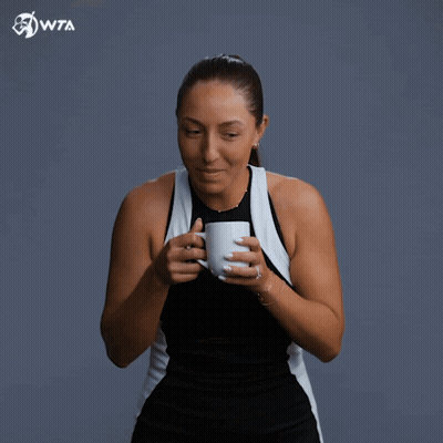 A Woman Drinking From A Cup With Wta Written On The Bottom Right GIF