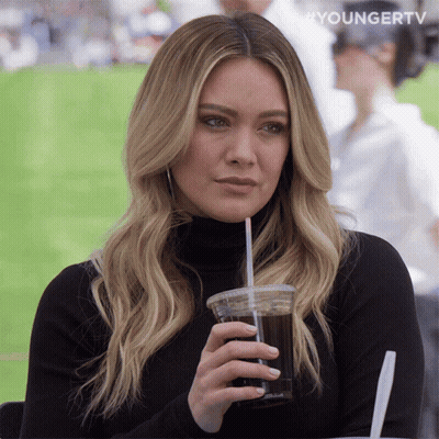 A Woman Drinking From A Plastic Cup With A Straw And The Words Youngertv On The Bottom GIF