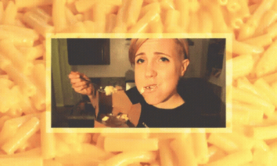 A Woman Eating Macaroni And Cheese With A Fork GIF