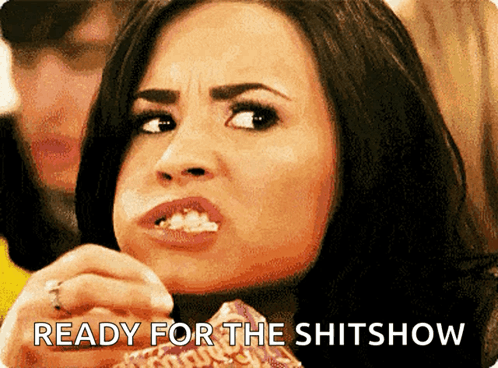 A Woman Eating Popcorn With The Words " Ready For The Shitshow " Behind Her GIF
