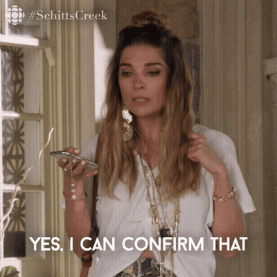 A Woman From Schitts Creek Is Holding A Cell Phone And Saying Yes I Can Confirm That GIF