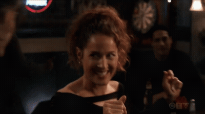 a woman giving a thumbs up in front of a dart board on ctv
