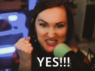 A Woman Giving A Thumbs Up In Front Of A Green Microphone With The Word Yes Written On The Screen GIF