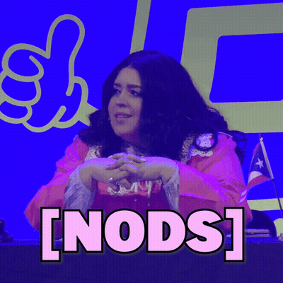 A Woman Giving A Thumbs Up In Front Of A Sign That Says ' Nods ' On It GIF