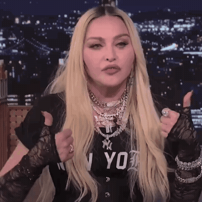 A Woman Giving A Thumbs Up Wearing A Black Shirt That Says Ny On It GIF