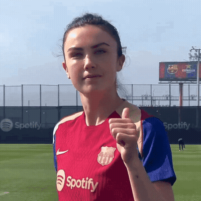A Woman Giving A Thumbs Up Wearing A Spotify Shirt GIF