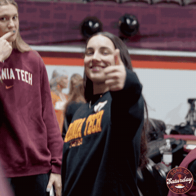 A Woman Giving A Thumbs Up Wearing A Sweater That Says Nia Tech GIF