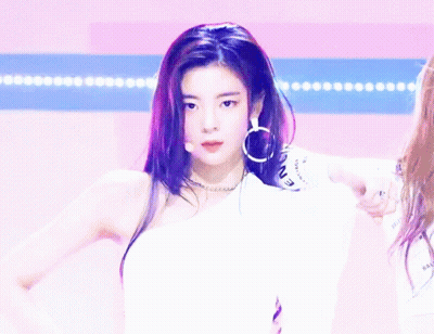 A Woman Giving A Thumbs Up While Wearing A White Shirt That Says Icon GIF