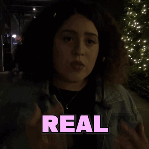 A Woman Giving The Middle Finger In Front Of A Sign That Says Like Shagarita GIF