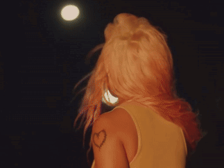 A Woman Has A Heart Tattoo On Her Shoulder GIF