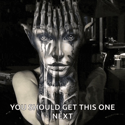 A Woman Has A Tattoo Of A Woman 'S Face On Her Arm GIF