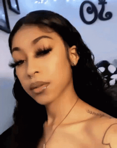 A Woman Has A Tattoo On Her Shoulder That Says " Courage " GIF