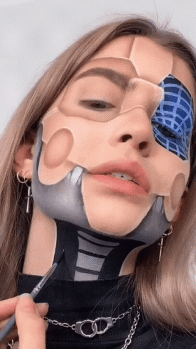A Woman Has Her Face Painted In The Shape Of A Skeleton GIF