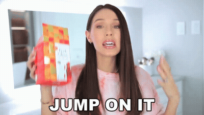 A Woman Holding A Bag Of Food With The Words Jump On It Behind Her GIF