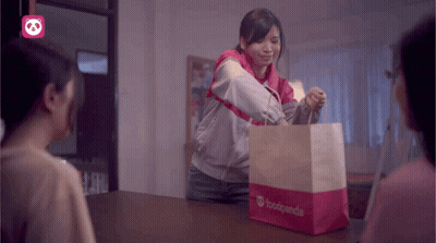 A Woman Holding A Bag That Says Foodpanda GIF