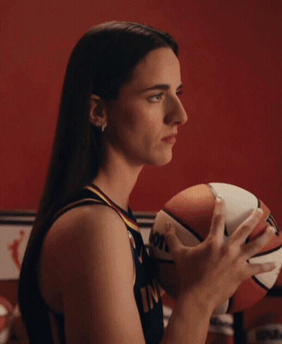 A Woman Holding A Basketball That Says Molten GIF
