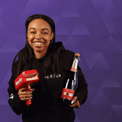 A Woman Holding A Bottle And A Box That Says Money Gun GIF
