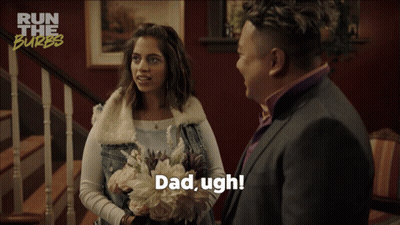 A Woman Holding A Bouquet Of Flowers Is Talking To A Man In A Suit Who Says Dad Ugh GIF