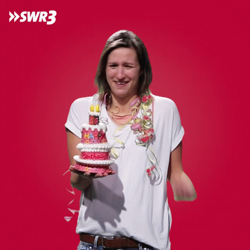 A Woman Holding A Cake That Says Happy Birthday GIF
