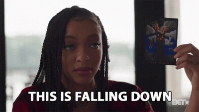 A Woman Holding A Card That Says This Is Falling Down GIF