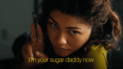 A Woman Holding A Cell Phone With The Words " I 'M Your Sugar Daddy Now " Above Her GIF