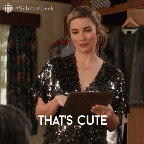A Woman Holding A Clipboard With The Words That 'S Cute Written On It GIF