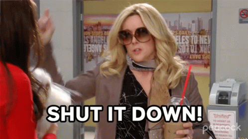 A Woman Holding A Drink And A Sign That Says Shut It Down GIF
