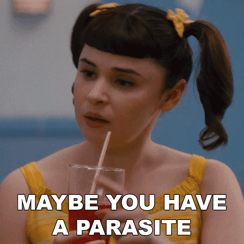 A Woman Holding A Drink With A Straw And Maybe You Have A Parasite Written On The Bottom GIF