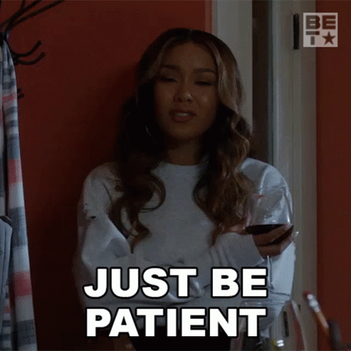 A Woman Holding A Glass Of Wine With The Words Just Be Patient Above Her GIF