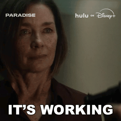 A Woman Holding A Gun With The Words It 'S Working Behind Her GIF