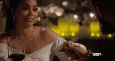 A Woman Holding A Man 'S Hand With A Bet Logo On The Bottom GIF