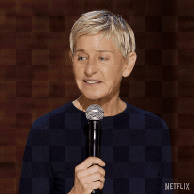 A Woman Holding A Microphone With A Netflix Logo On The Bottom Right GIF
