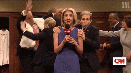 A Woman Holding A Microphone With Cnn On The Screen GIF