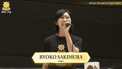 A Woman Holding A Microphone With The Name Ryoko Sakimura On The Screen GIF