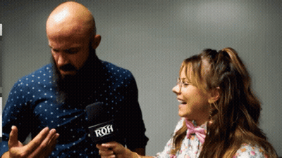 A Woman Holding A Microphone With The Word Roh On It GIF