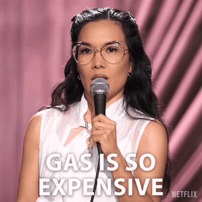 A Woman Holding A Microphone With The Words Gas Is So Expensive Written On The Bottom GIF