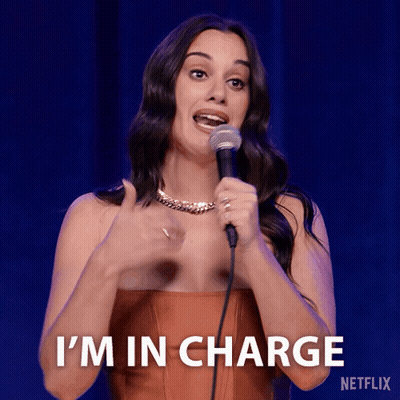 A Woman Holding A Microphone With The Words I 'M In Charge On The Bottom GIF
