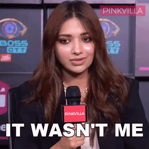 A Woman Holding A Microphone With The Words It Wasn 'T Me Written On It GIF